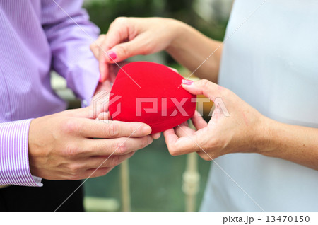Asian man presented gift of love to his lady in celebration of Valentine's Day / wedding anniversary 13470150