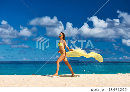 Woman with sarong at beach 13471296