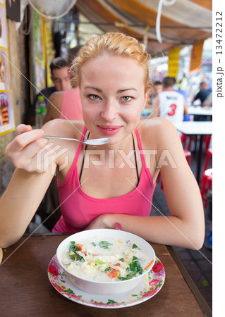 Traveler eating traditional thai Tom Yum soup. Traveler eating traditional thai Tom Yum soup. 13472212