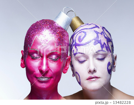Two women posing as Christmas ornaments Two women posing as Christmas ornaments 13482228