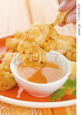 Squid Tempura Skewers - Battered and deep fried calamari on skewers. Served with mango dip. 13482820