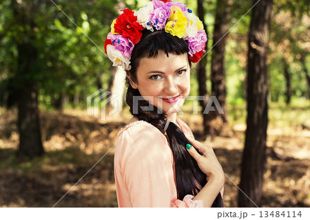 woman in wreath of roses on her head 13484114