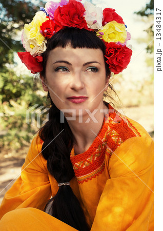 woman in wreath of roses on her head 13484317