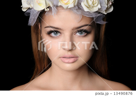 Beautiful woman with a wreath of flowers 13490876