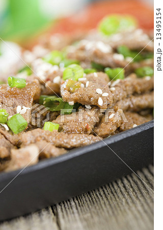 Bulgogi - Korean grilled marinated beef served with green chillies, garlic and kimchi . Bulgogi - Korean grilled marinated beef served with green chillies, garlic and kimchi . 13495154