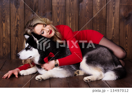 Young girl wearing red dress with her husky dog Young girl wearing red dress with her husky dog 13497012