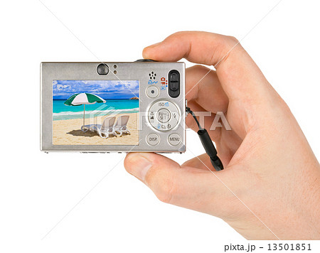 Hand with camera and beach landscape (my photo) 13501851