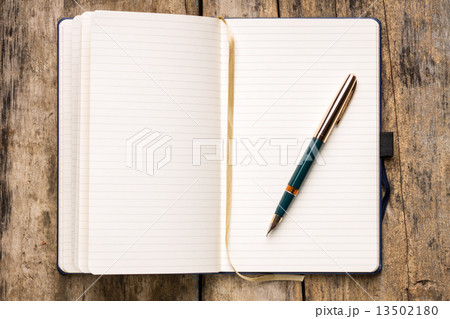 Opened empty notebook on wooden table 13502180