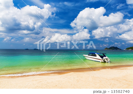 White boat on a beautiful beach 13502740