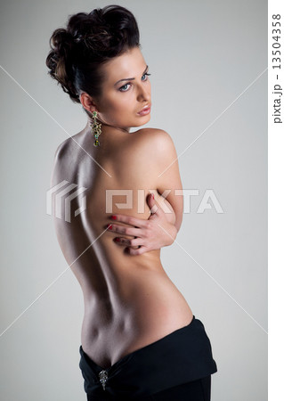 Sexy silhouette of a woman with bare back Sexy silhouette of a woman with bare back 13504358