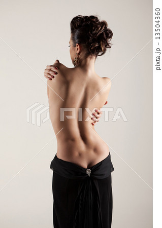 Sexy silhouette of a woman with bare back Sexy silhouette of a woman with bare back 13504360