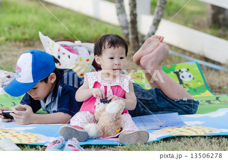 Happy Asian children relaxing in the park outdoor. Happy Asian children relaxing in the park outdoor. 13506278