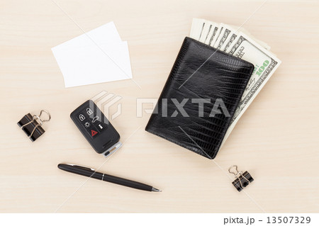 Money cash wallet and car remote key on wooden table 13507329