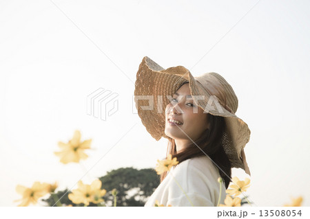 Asian girl smiling in the flower garden Asian girl smiling in the flower garden 13508054