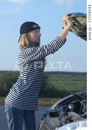 Young Blond Woman With Her Broken Car 13508088