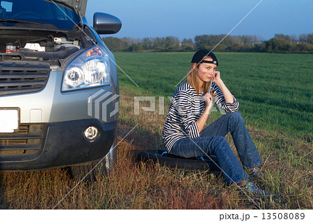 Young Blond Woman With Her Broken Car 13508089