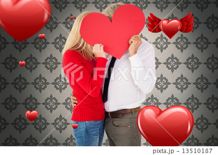 Composite image of handsome man getting a heart card form wife 13510187