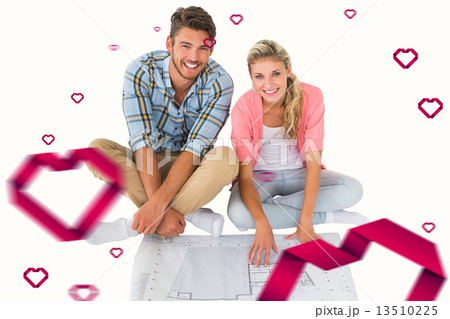 Composite image of attractive young couple sitting looking at bl 13510225