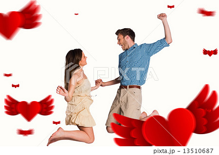 Composite image of cheerful young couple jumping Composite image of cheerful young couple jumping 13510687