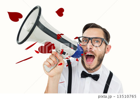 Composite image of geeky businessman shouting through megaphone 13510765