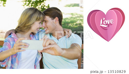 Composite image of smiling couple sitting on bench in the park t Composite image of smiling couple sitting on bench in the park t 13510829