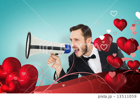 Composite image of geeky businessman shouting through megaphone 13511059