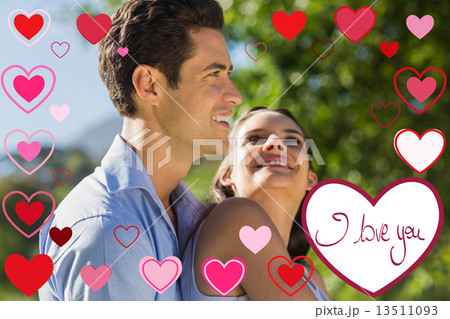 Composite image of loving and happy young couple at park Composite image of loving and happy young couple at park 13511093