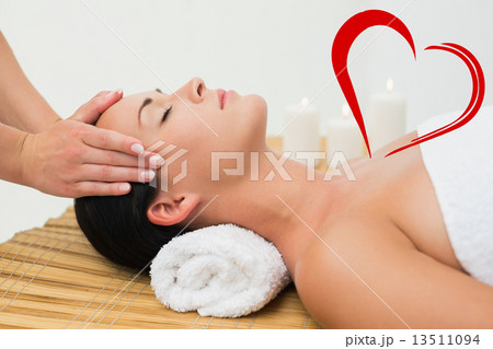 Composite image of peaceful brunette enjoying a facial massage Composite image of peaceful brunette enjoying a facial massage 13511094