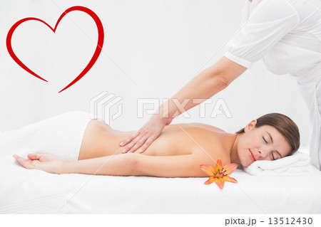 Composite image of attractive woman receiving back massage at sp Composite image of attractive woman receiving back massage at sp 13512430