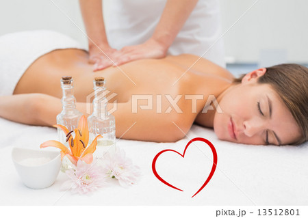 Composite image of attractive woman receiving back massage at sp Composite image of attractive woman receiving back massage at sp 13512801