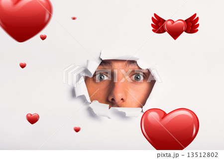 Composite image of young man looking through paper rip 13512802