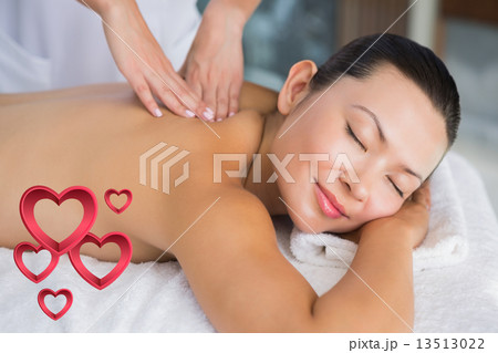 Composite image of content brunette getting a back massage Composite image of content brunette getting a back massage 13513022