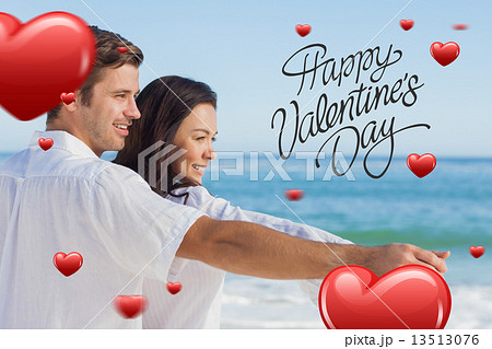Composite image of romantic couple relaxing on the beach 13513076