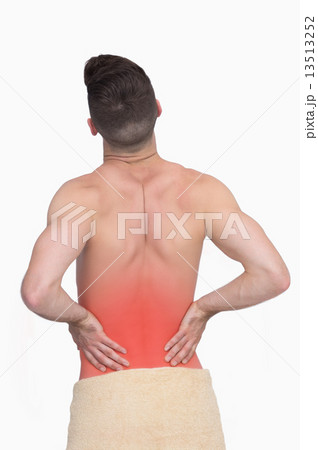 Rear view of shirtless man with back pain Rear view of shirtless man with back pain 13513252