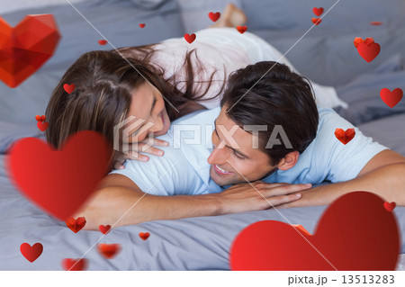 Composite image of couple having fun on the bed 13513283