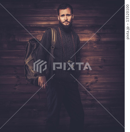 Handsome man wearing cardigan with backpack and vintage camera 13520100