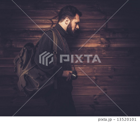 Handsome man wearing cardigan with backpack and vintage camera 13520101