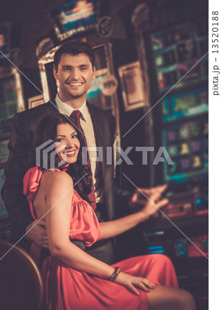 Beautiful couple near slot machine in a casino 13520188