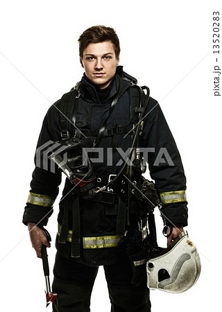 Young firefighter with helmet and axe isolated on white 13520283
