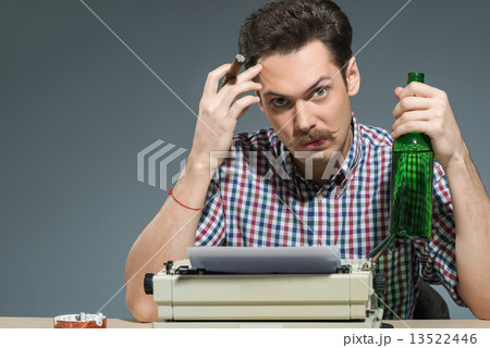 Author smoking cigar and drinking alcohol at typewriter Author smoking cigar and drinking alcohol at typewriter 13522446