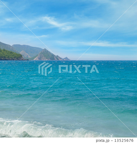 seascape, blue sky and mountainous coast 13525676