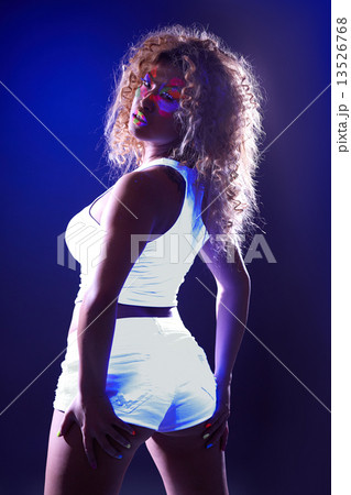 Sexy girl posing in luminous clothes under UV  13526768
