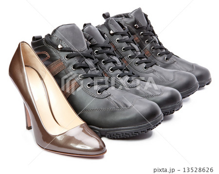 Men's boots and elegant female shoes on white background Men's boots and elegant female shoes on white background 13528626