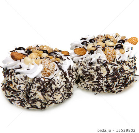 Cake with nuts and whipped cream on a white background.. Cake with nuts and whipped cream on a white background.. 13529802