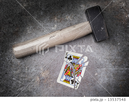 Hammer with a broken card, king of clubs 13537548
