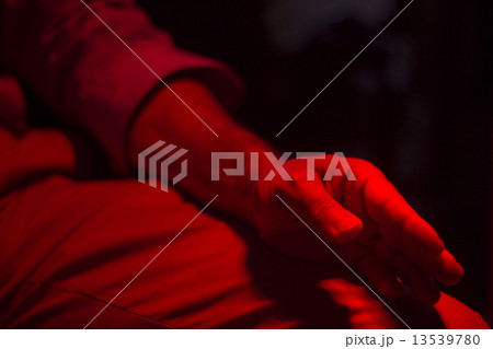 Hand of patient under red rehabilitation clinic heat lamp 13539780