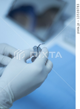 Dental nurse attaching ultrasound teeth cleaning attachment 13539783