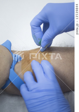 Nurse and male patient blood sample donation 13539844