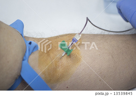 Nurse and male patient blood sample donation 13539845