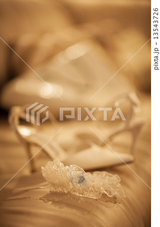 Bridal garter belt lingerie wedding shoe of bride on bed 13543726